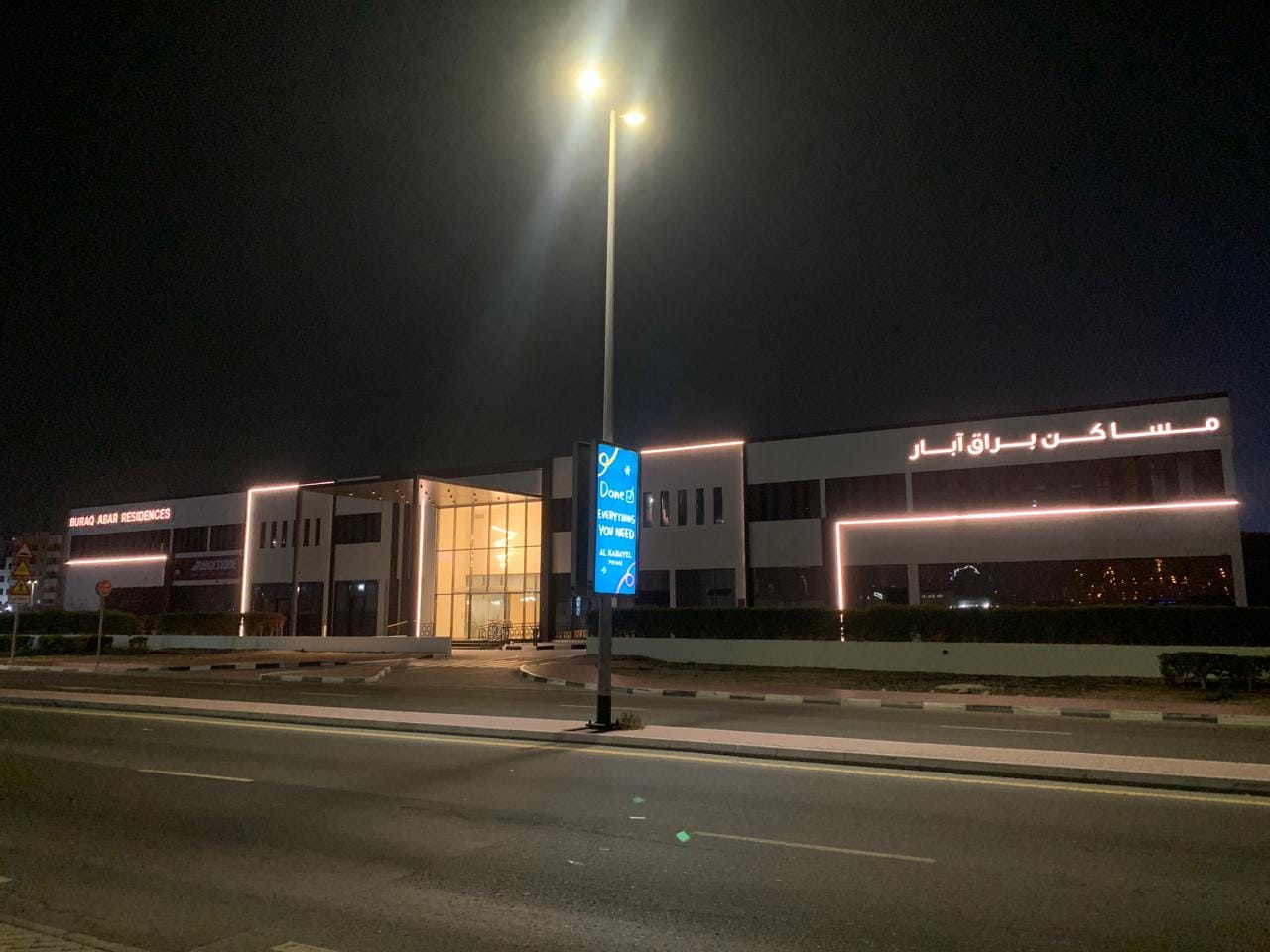 Buraq Abar Residences exterior lit up in the evening
