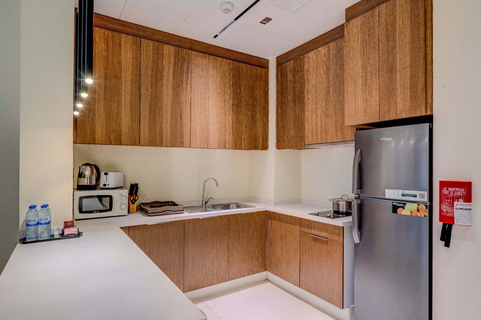 Full kitchen with timber cabinetry and stainless appliances